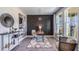 Stylish home office with modern decor, geometric wall paneling, and natural light from large windows at 6697 Flint Creek Dr, Land O Lakes, FL 34638