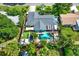 Aerial view of a charming home featuring a private backyard oasis with a sparkling pool and lush landscaping at 6844 34Th N Ave, St Petersburg, FL 33710