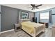 Bedroom with a window, ceiling fan, and grey and blue walls at 6844 34Th N Ave, St Petersburg, FL 33710