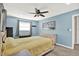 Bedroom features a window, ceiling fan, and blue walls at 6844 34Th N Ave, St Petersburg, FL 33710