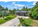 Home exterior with lush landscaping, a well-manicured lawn, and a private driveway at 6844 34Th N Ave, St Petersburg, FL 33710