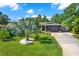 Charming home with a well-manicured lawn, palm tree, and modern exterior accents at 6844 34Th N Ave, St Petersburg, FL 33710