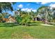 Well-maintained front yard with lush landscaping and a beautiful palm tree at 6844 34Th N Ave, St Petersburg, FL 33710