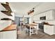 Modern kitchen with white cabinets, wood countertops, stainless steel appliances, and an eat-in island at 6844 34Th N Ave, St Petersburg, FL 33710
