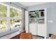 Bright laundry area equipped with washer, dryer, and convenient storage shelving at 6844 34Th N Ave, St Petersburg, FL 33710