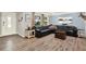Bright living room with hardwood floors, a plush leather couch, and large windows for ample natural light at 6844 34Th N Ave, St Petersburg, FL 33710