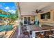 Cozy outdoor patio space with comfortable seating area, dining area, and a pool view at 6844 34Th N Ave, St Petersburg, FL 33710