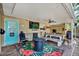 Covered patio features an outdoor television, fan, dining area, and cozy fire pit seating at 6844 34Th N Ave, St Petersburg, FL 33710