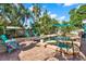 Backyard oasis featuring a large swimming pool, in-ground hot tub, brick patio, and lush tropical landscaping at 6844 34Th N Ave, St Petersburg, FL 33710