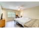 Well-lit bedroom featuring a window, wood floors, and a ceiling fan for comfortable living at 6865 Circle Creek Dr, Pinellas Park, FL 33781