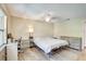 Bright bedroom featuring a window, wood floors, and a ceiling fan for comfortable living at 6865 Circle Creek Dr, Pinellas Park, FL 33781