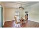 Dining area with luxury vinyl plank floors, glass top table with seating, and view of the kitchen at 6865 Circle Creek Dr, Pinellas Park, FL 33781