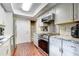 Well-lit kitchen with stainless steel appliances, white cabinets, and granite countertops at 6865 Circle Creek Dr, Pinellas Park, FL 33781