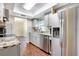 Bright kitchen with stainless steel appliances and granite countertops and an eat-in dining area at 6865 Circle Creek Dr, Pinellas Park, FL 33781