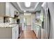 Efficient kitchen layout with stainless steel appliances, granite counters, and wood flooring at 6865 Circle Creek Dr, Pinellas Park, FL 33781