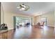 Inviting living room with ceiling fan, sliding doors to screened patio, and luxury vinyl plank flooring at 6865 Circle Creek Dr, Pinellas Park, FL 33781