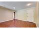 Open-concept living space with wood-look flooring and a door to another room at 6865 Circle Creek Dr, Pinellas Park, FL 33781