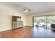 Spacious living area with sliding glass doors, ceiling fan, and wood-look flooring at 6865 Circle Creek Dr, Pinellas Park, FL 33781