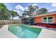 Outdoor pool area surrounded by the home's bright exterior and lush greenery at 6865 Circle Creek Dr, Pinellas Park, FL 33781