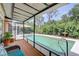 Screened porch overlooks a sparkling outdoor pool and lush tropical landscaping at 6865 Circle Creek Dr, Pinellas Park, FL 33781