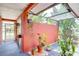 Enclosed outdoor space with tiled floors, a translucent roof, and view to the tropical backyard at 6865 Circle Creek Dr, Pinellas Park, FL 33781