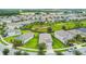A high angle showcases a backyard with lush lawn, privacy fence, and a prime location in the community at 9816 Ivory Dr, Sun City Center, FL 33573