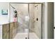 Tiled shower with glass doors and bronze fixtures in a bathroom at 9816 Ivory Dr, Sun City Center, FL 33573