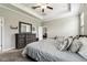 Bedroom features tray ceiling, neutral walls, carpet, and dresser with mirror at 9816 Ivory Dr, Sun City Center, FL 33573