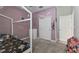Cozy bedroom with lilac walls, white trim, carpet, and closet at 9816 Ivory Dr, Sun City Center, FL 33573