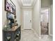 Inviting foyer with tile floors, console table, and view into the adjacent room at 9816 Ivory Dr, Sun City Center, FL 33573