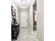 Inviting foyer with decorative table, tile floors, and front door at 9816 Ivory Dr, Sun City Center, FL 33573