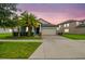 Charming single-Gathering home with a well-manicured lawn, mature trees, and a two-car garage at 9816 Ivory Dr, Sun City Center, FL 33573
