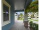 Inviting front porch with brick flooring and stone support columns, offering a welcoming entrance at 9816 Ivory Dr, Sun City Center, FL 33573