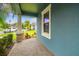 Charming front porch featuring brick flooring, stone support columns and a view of the street at 9816 Ivory Dr, Sun City Center, FL 33573
