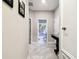 Hallway with tiled floor and view of bathroom featuring a world map shower curtain at 9816 Ivory Dr, Sun City Center, FL 33573