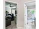 Hallway view of an office and bathroom featuring a world map shower curtain at 9816 Ivory Dr, Sun City Center, FL 33573