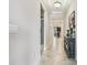 Hallway leading to the kitchen with a decorative table at 9816 Ivory Dr, Sun City Center, FL 33573