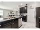 Open kitchen features stainless steel appliances and a breakfast bar overlooking the adjacent living area at 9816 Ivory Dr, Sun City Center, FL 33573