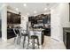 Stylish kitchen showcases dark cabinetry, granite countertops, stainless appliances, and a functional center island at 9816 Ivory Dr, Sun City Center, FL 33573