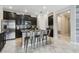Modern kitchen features granite counters, an island with seating, and stainless steel appliances at 9816 Ivory Dr, Sun City Center, FL 33573