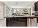 Kitchen island features granite counters and is open to the connected dining and living areas at 9816 Ivory Dr, Sun City Center, FL 33573