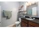Cozy bathroom featuring granite countertop, stylish fixtures, and decorative shelving for storage at 10436 Villa View Cir, Tampa, FL 33647