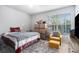 Comfortable bedroom with bright window, plush rug, and yellow chair with ottoman at 10436 Villa View Cir, Tampa, FL 33647