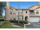 Home exterior showcasing attached garage, bay window, and quaint balcony, surrounded by neatly trimmed bushes and green space at 10436 Villa View Cir, Tampa, FL 33647