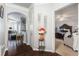 Inviting hallway features hardwood floors, arched doorways, and provides access to the dining area and primary bedroom at 10436 Villa View Cir, Tampa, FL 33647