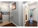 Bright hallway with dark wood floors and staircase leading to bedroom and bathroom at 10436 Villa View Cir, Tampa, FL 33647