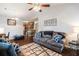 Spacious living room with vaulted ceiling, hardwood floors, and a comfortable seating area with views to the kitchen at 10436 Villa View Cir, Tampa, FL 33647