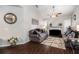 Inviting living room featuring hardwood floors, comfortable seating, a fireplace, and natural light from the windows at 10436 Villa View Cir, Tampa, FL 33647