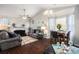 Bright living room features hardwood floors, neutral walls, fireplace, and ample natural light from the many windows at 10436 Villa View Cir, Tampa, FL 33647