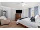 Spacious main bedroom featuring a ceiling fan, a dresser with a TV, neutral walls and carpet at 10436 Villa View Cir, Tampa, FL 33647